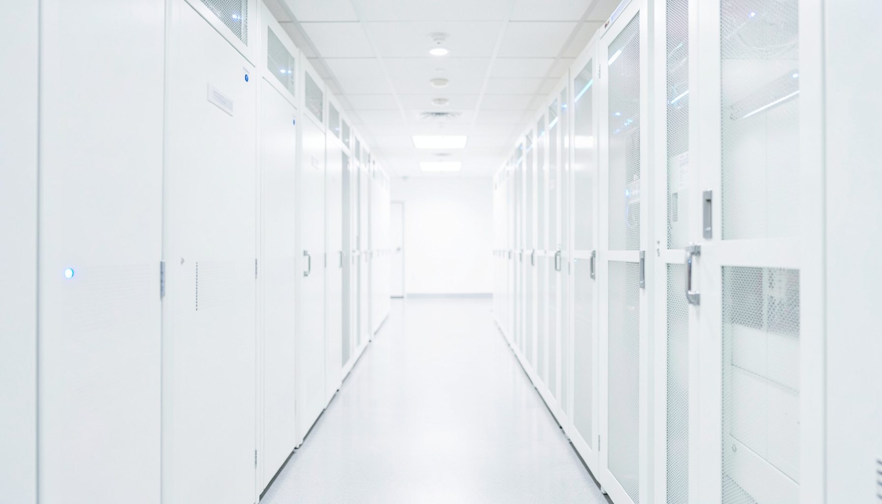 A bright, airy server-room corridor with clean white racks and subtle blue indicator lights, conveying enterprise infrastructure and reliability.